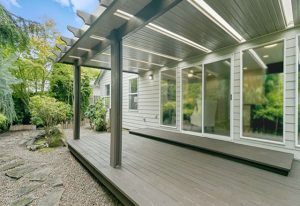 image of a residential home with multiple windows and a large covered deck